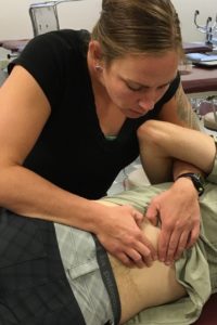 Photo of Katie Hicks, DPT at Carolina Physical Therapy, working on a patient. 