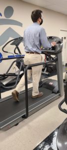 photo of a patient at Carolina Physical Therapy on a treadmill doing blood flow restriction exercises. 