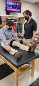 Photo of a patient with Matt at Carolina Physical Therapy, working on Blood Flow Restriction (BFR) training in our Forest Acres office in Columbia, SC.