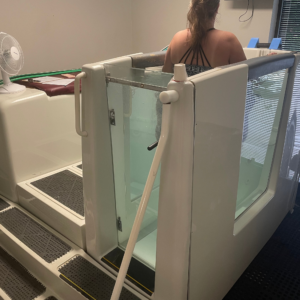 Patient undergoing Aquatic Therapy with the AquaCiser at Carolina PT.