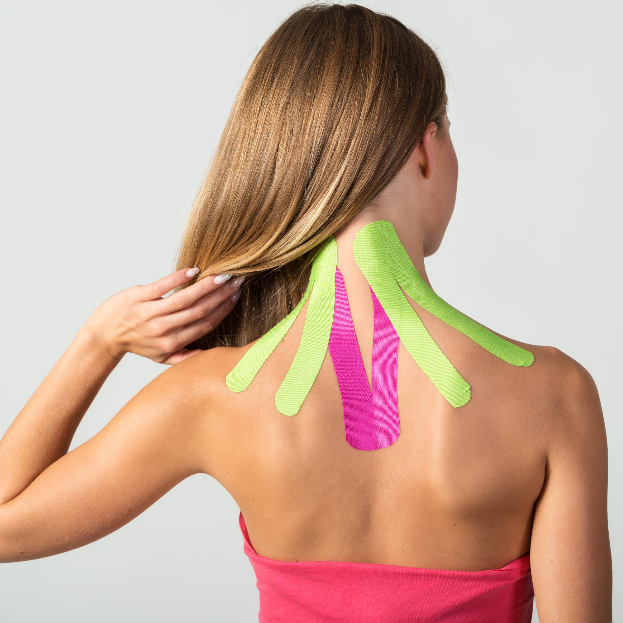 Athlete with Kinesio tape applied to the neck, aiding in recovery from a sports-related injury