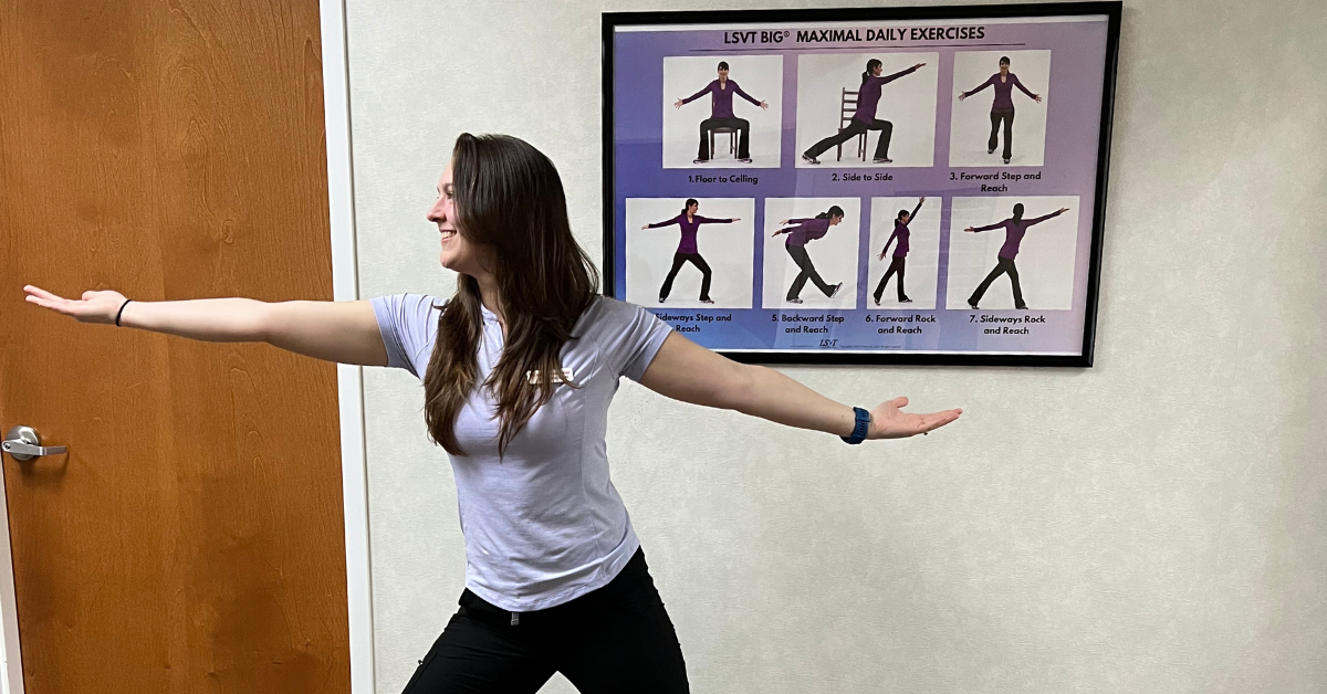 Physical Therapist Megan Leach from Northeast Columbia Carolina PT stands confidently in front of an LSVT BIG poster.