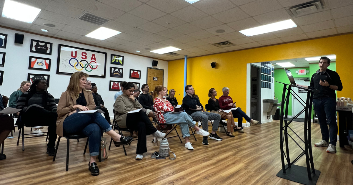 Photo of Brandon Young, PT at Carolina Physical Therapy & Sports Medicine, leading a talk with Strictly Running to people in the community interested in running.